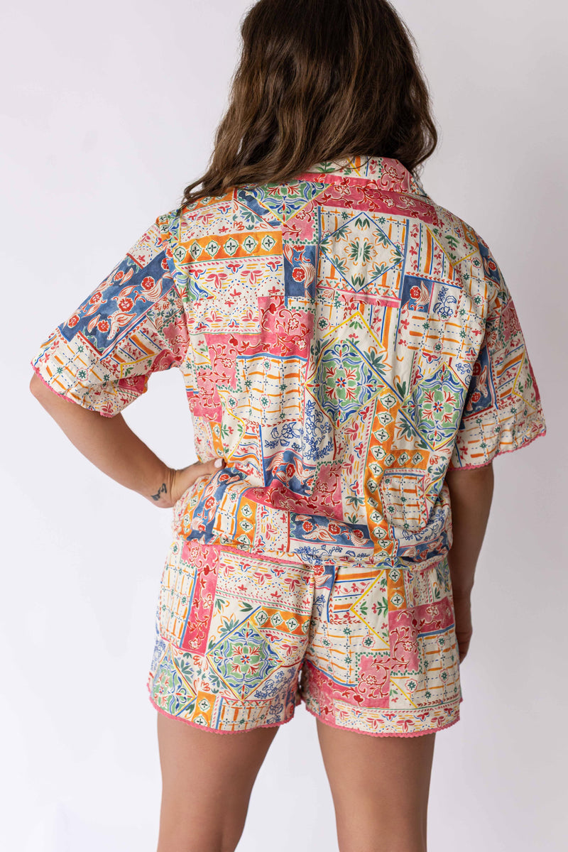 Weaving Color patchwork button-up top with colorful geometric and floral patterns on a model from the back