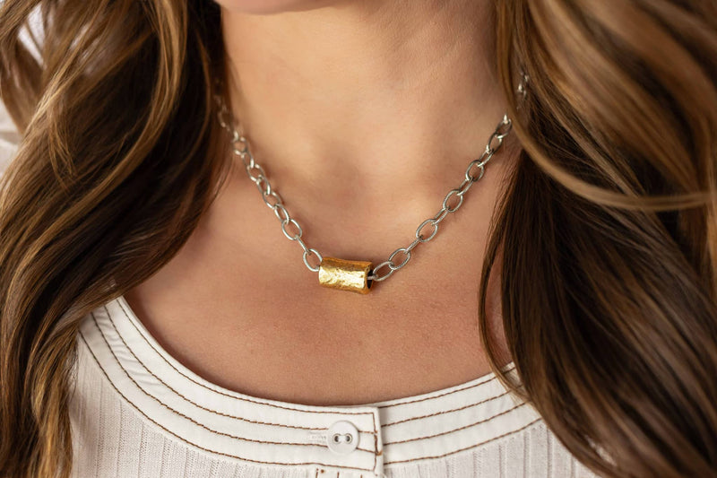 Weaving Color beaded tube necklace with gold centerpiece on silver chain worn by woman