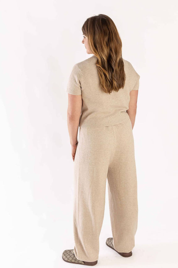 Woman wearing beige knitwear set with short sleeves and wide-leg pants from Weaving Color