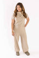 Woman wearing beige knitwear set with short sleeves and wide-leg pants by Weaving Color