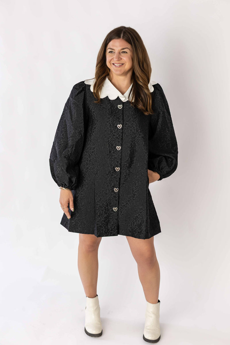Weaving Color black textured mini dress with collar and puff sleeves worn with white boots