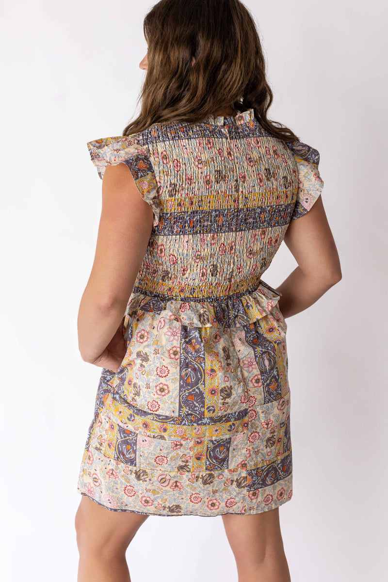 Rear view of woman wearing Weaving Color boho paisley dress with ruffled sleeves and smocked waist