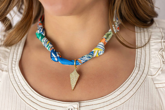Weaving Color colorful fabric necklace with geometric gold pendant worn on model's neck