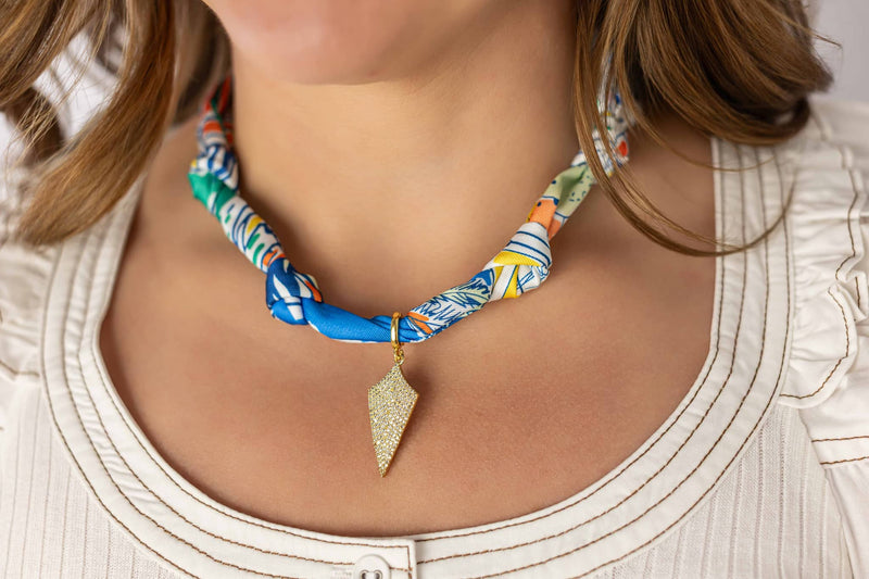 Weaving Color colorful fabric necklace with geometric gold pendant worn on model's neck