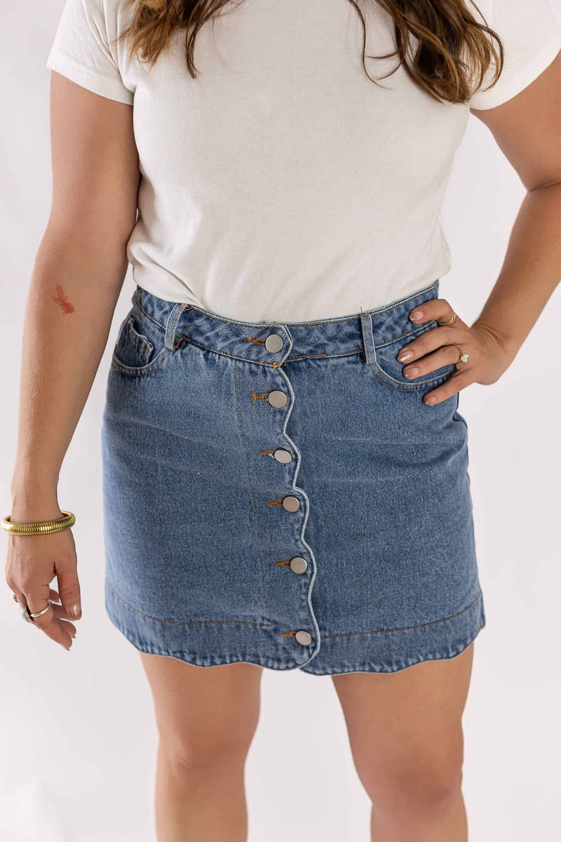 Weaving Color blue denim mini skirt with front button closure worn with white t-shirt