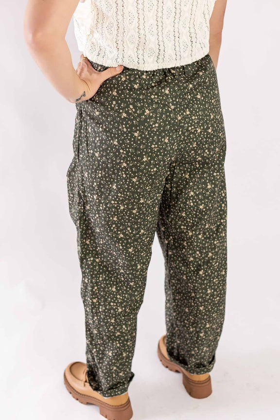 Weaving Color floral print drawstring pants worn by a woman with tan boots and white lace top