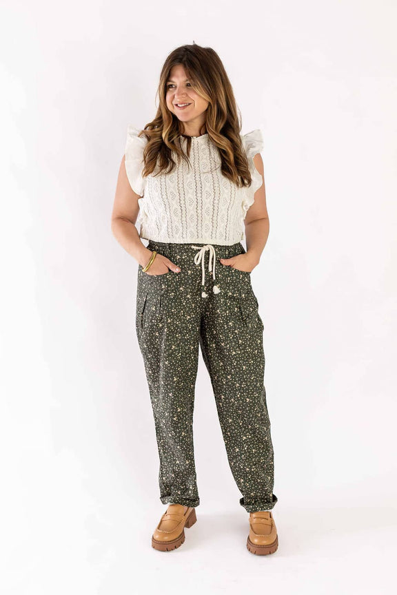 Woman wearing Weaving Color floral drawstring pants with pockets and casual white top