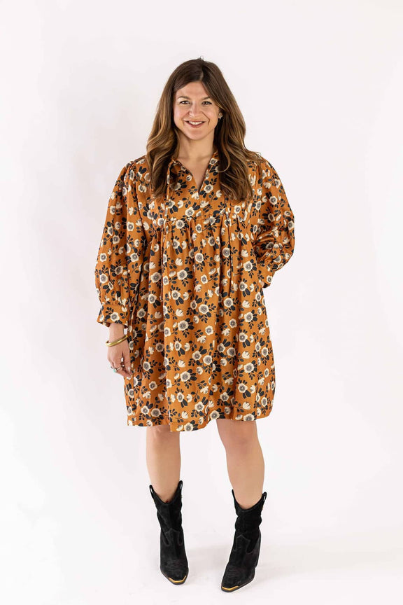Woman wearing Weaving Color dress floral with orange background and black boots