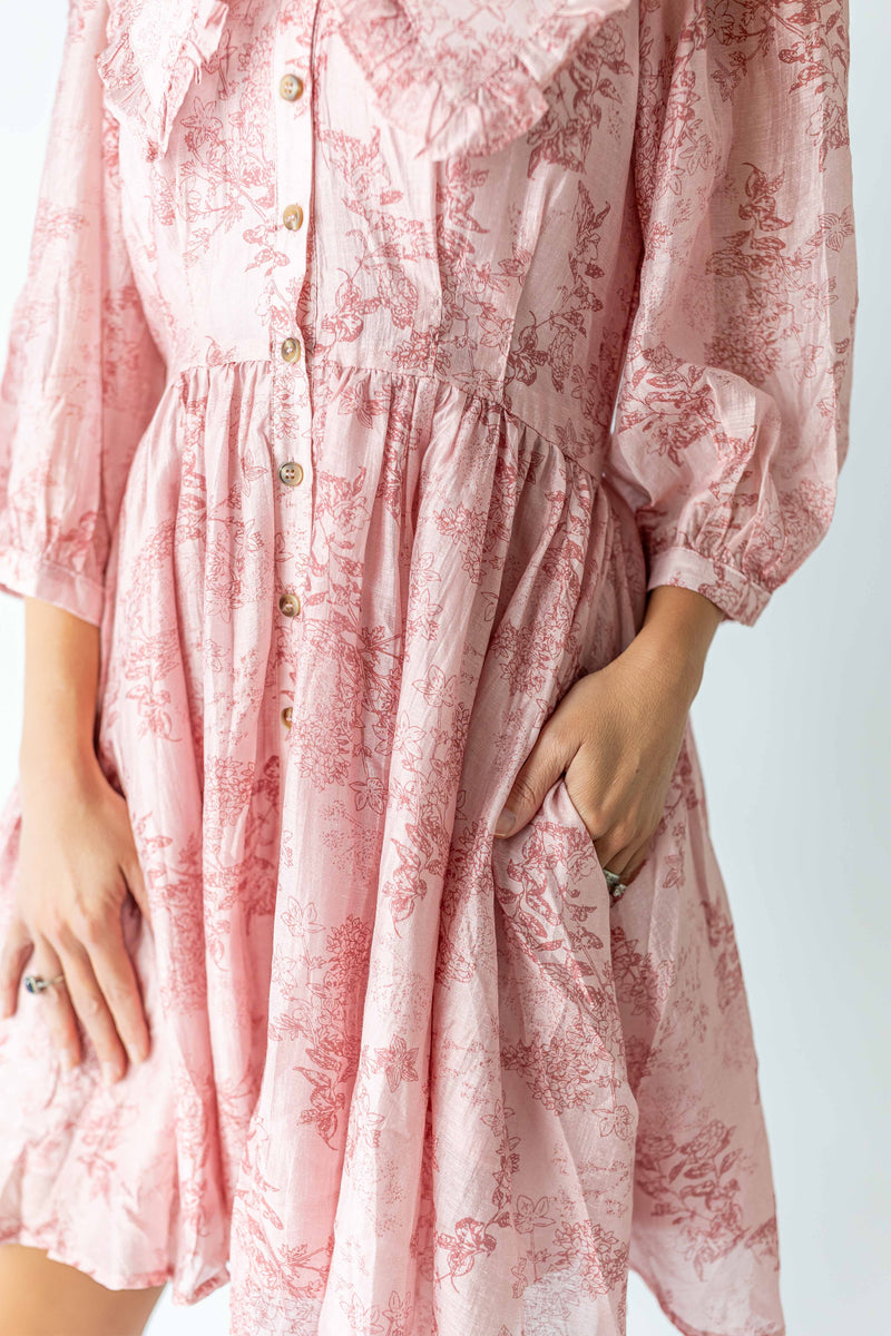 Close-up of feminine floral print dress in light pink with buttons and gathered waist by My Store