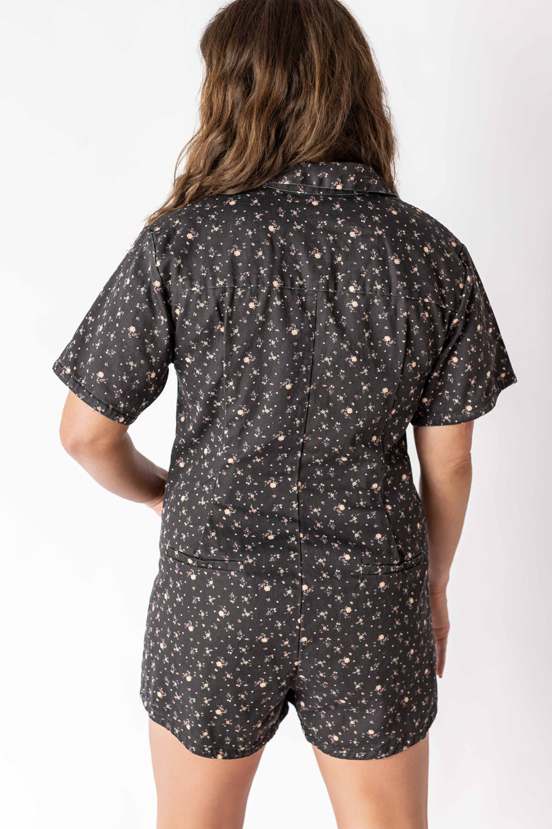 Back view of woman wearing Weaving Color floral zip romper with short sleeves and shorts
