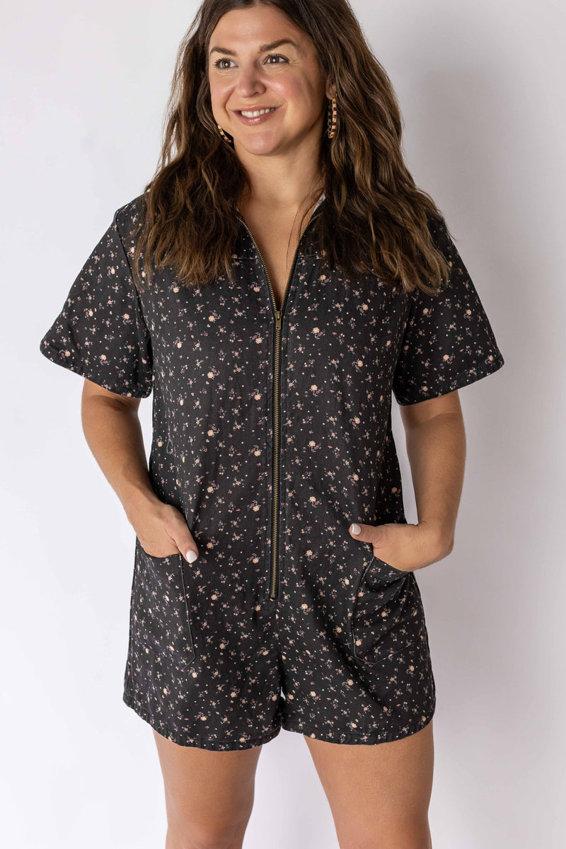 Weaving Color floral zip romper with short sleeves and front pockets worn by smiling woman