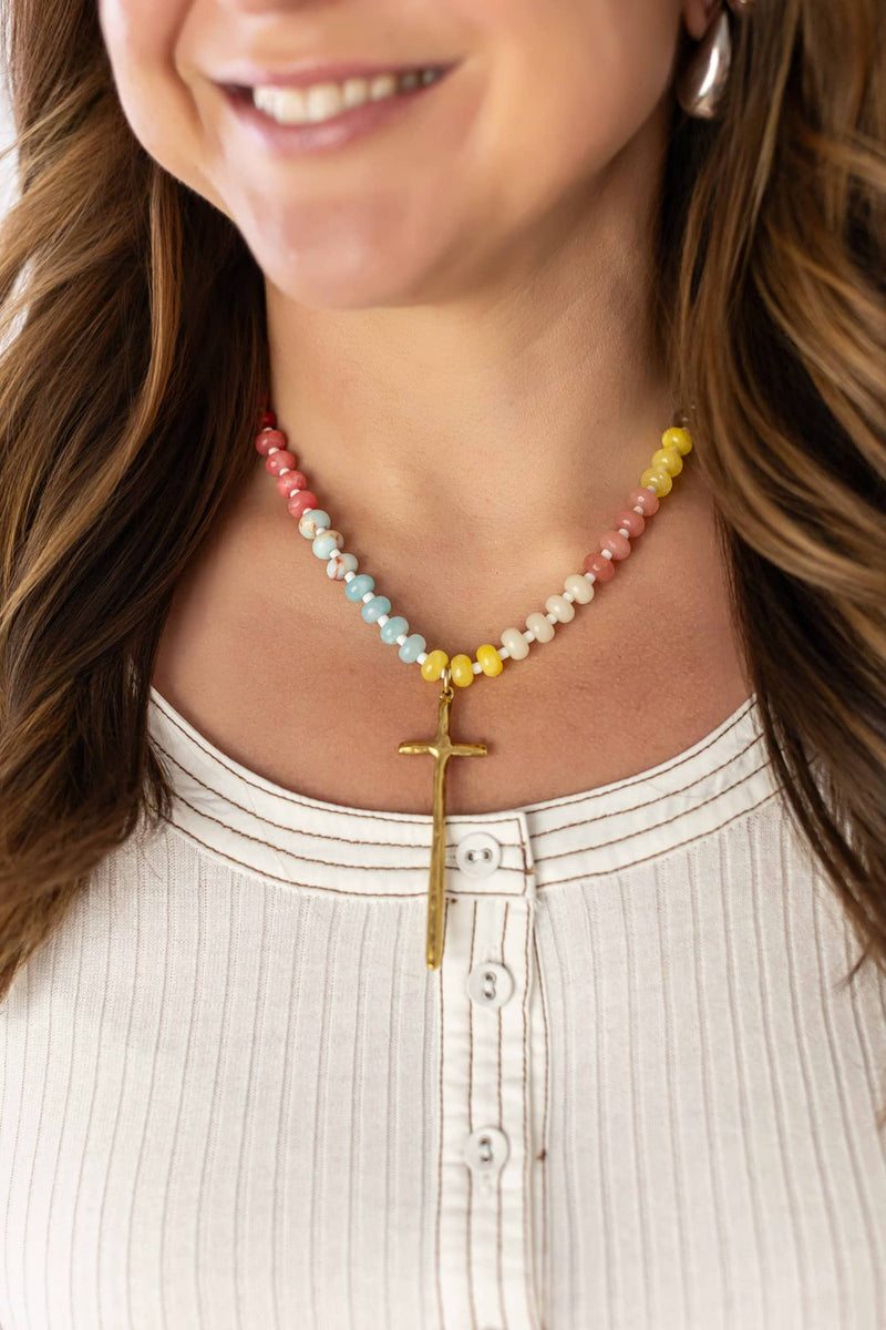 Woman wearing Weaving Color colorful beaded grace necklace with gold cross pendant