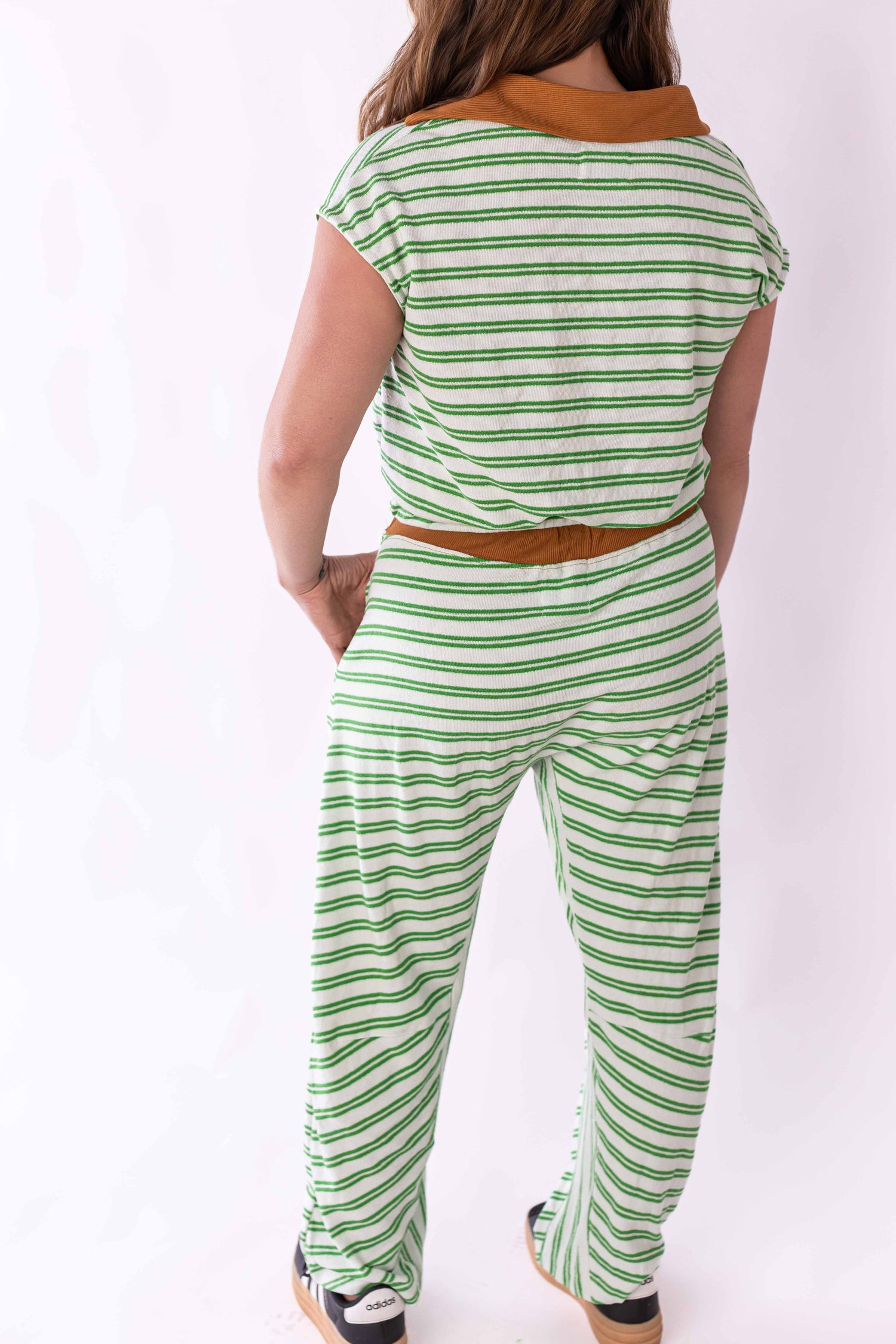 Back view of woman wearing Weaving Color green stripe lounge set with brown collar and waistband