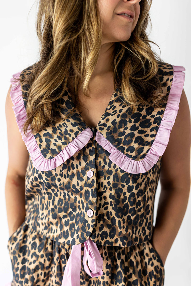 Leopard print top for women with large pink ruffle collar and button-down front