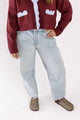Weaving Color light wash blue jeans with relaxed fit worn with burgundy cardigan and patterned loafers