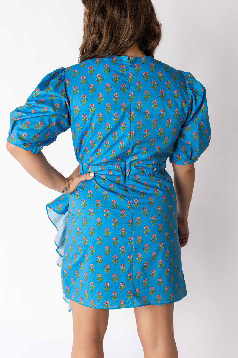 Back view of woman wearing Weaving Color ruched puff sleeve mini dress with blue floral pattern