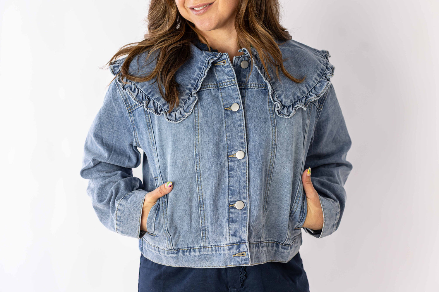 Weaving Color ruffle collar denim jacket in light blue worn by model with hands in pockets