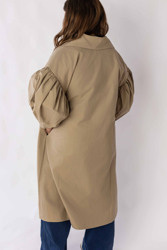 Back view of scallop edge puff sleeve trench coat by Weaving Color in beige color