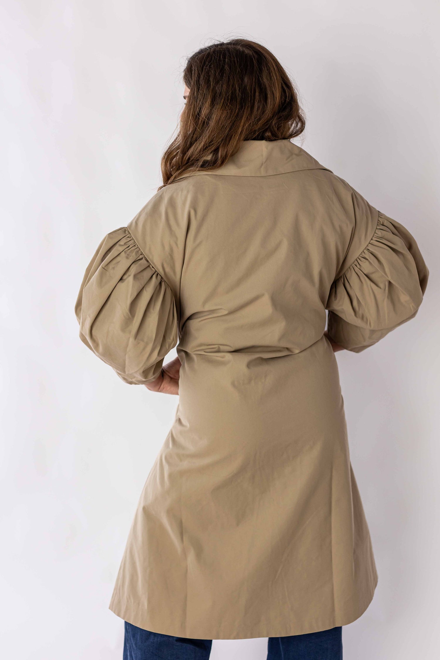 Back view of scallop edge puff sleeve trench coat by Weaving Color in beige with voluminous puff sleeves