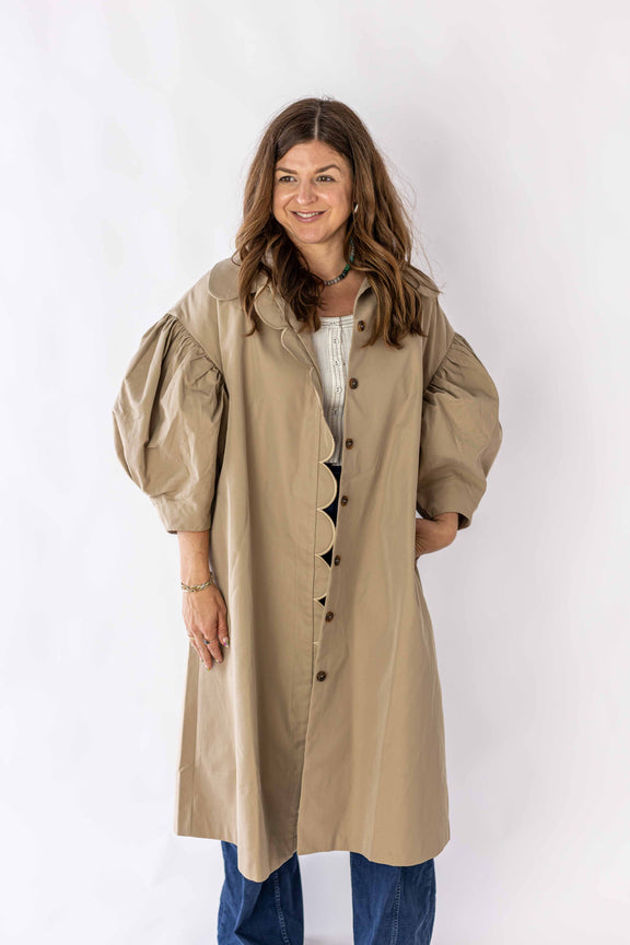 Weaving Color beige scallop edge puff sleeve trench coat worn by woman with long hair