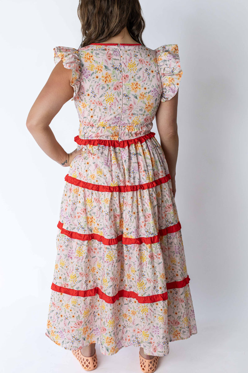 Back view of floral summer maxi dress by Weaving Color with red trim and flutter sleeves