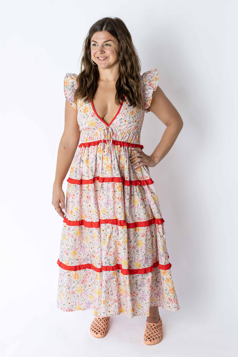 Weaving Color floral summer maxi dress with red trim and flutter sleeves on model