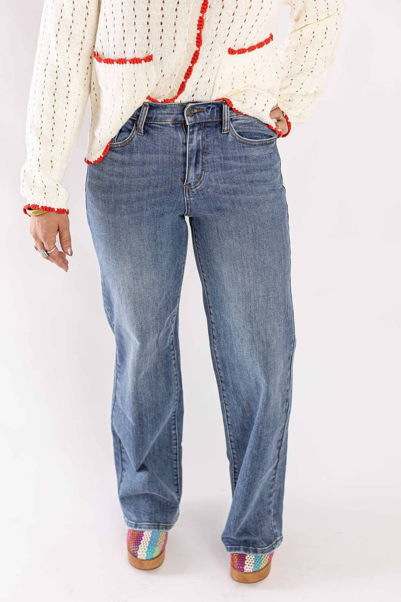 Weaving Color wide leg denim jeans in blue worn with a white knit sweater and colorful shoes