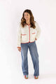 Woman wearing Weaving Color wide leg denim jeans paired with a white knitted cardigan