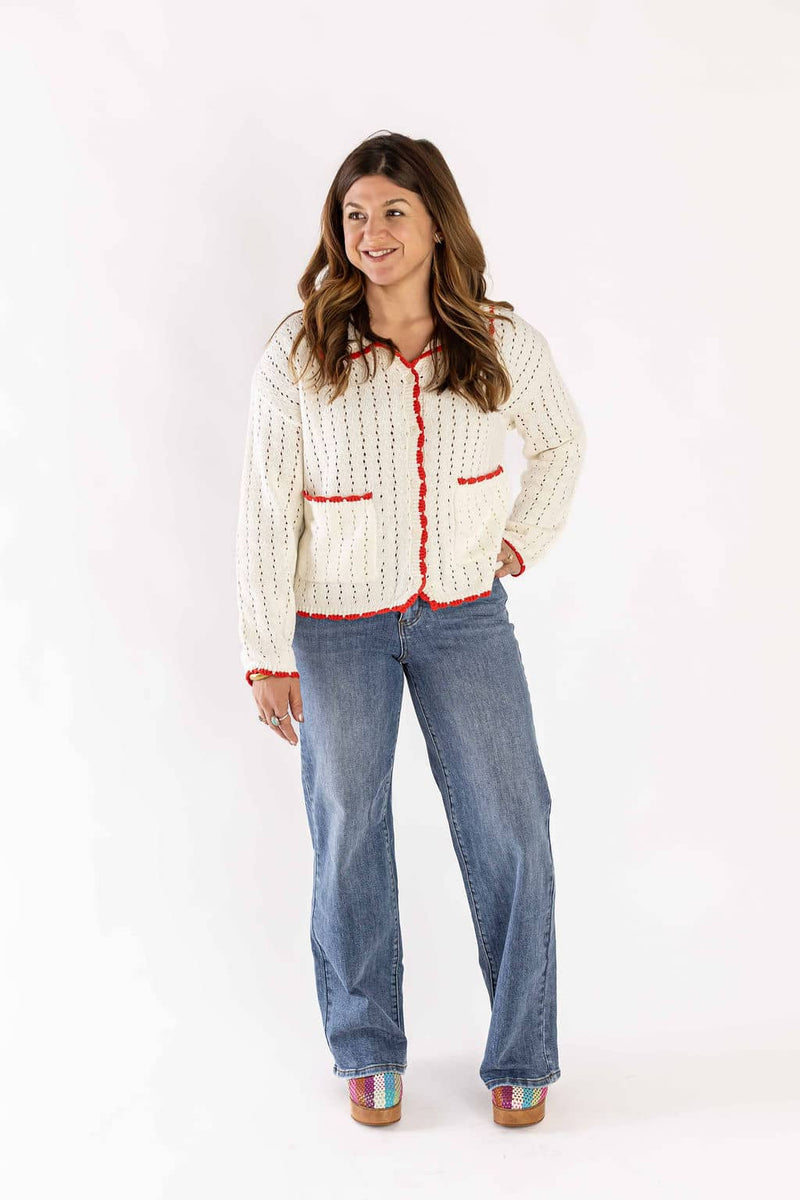Woman wearing Weaving Color wide leg denim jeans paired with a white knitted cardigan