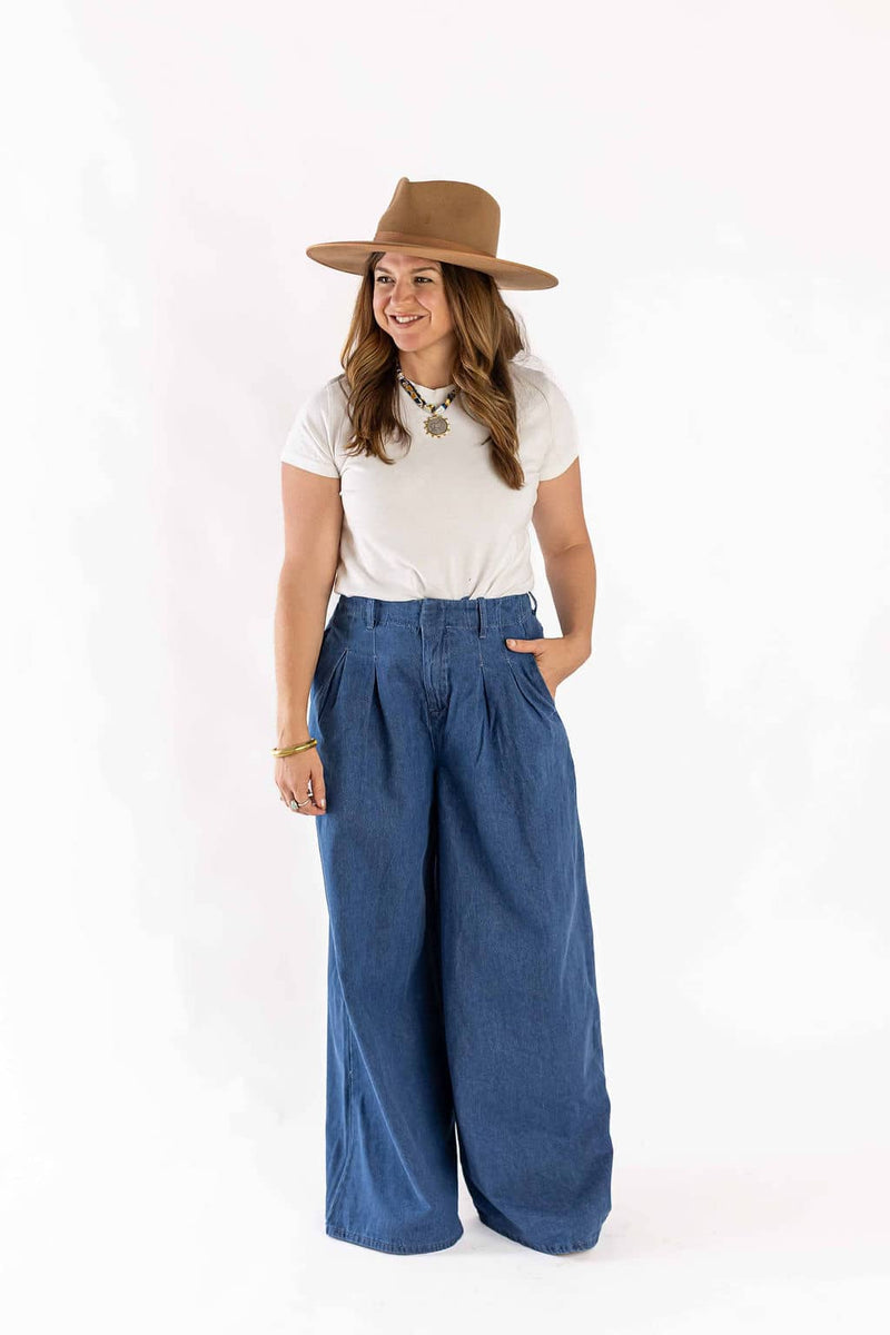 Woman wearing Weaving Color wide-leg jeans in blue with a white t-shirt and brown hat